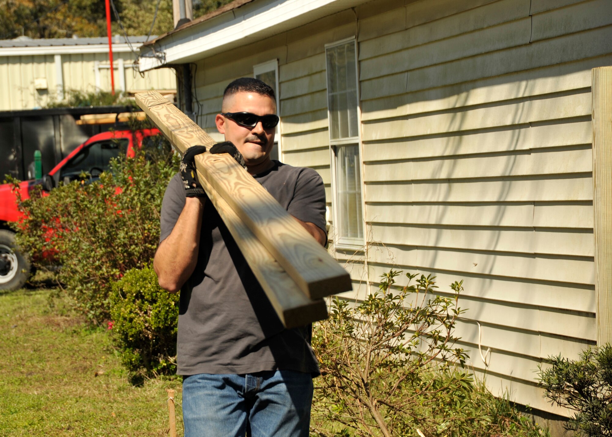Master Sgt. Jose Nunez, then 325th Force Support Squadron first sergeant, carries supplies to a Habitat for Humanity site March 10. The March 10 Comprehensive Airman Fitness Day recently earned the Air Combat Command’s Best CAF Day of the 1st Quarter. (U.S. Air Force photo by Airman 1st Class Solomon Cook)