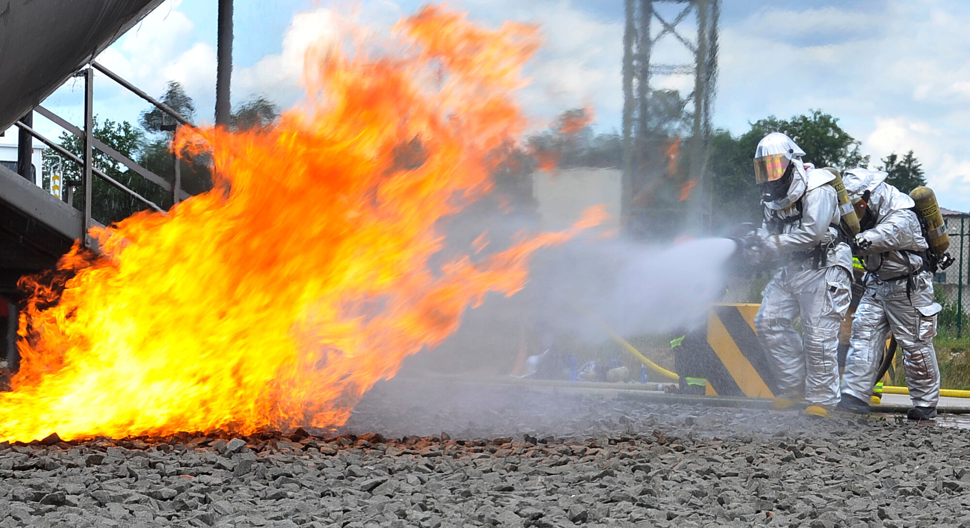 Civil Engineer Squadron firefighters put out a fire on the simulated aircraft during Silver Flag training on Ramstein Air Base, Germany, June 5, 2014. The CES firefighters’ Silver Flag training gave them the opportunity to put out fires during multiple scenarios. Silver Flag's main goal is to train Airmen for contingency deployments and assists in building partnership capacities by training allied partners.  (U.S. Air Force photo/Airman Larissa Greatwood)
