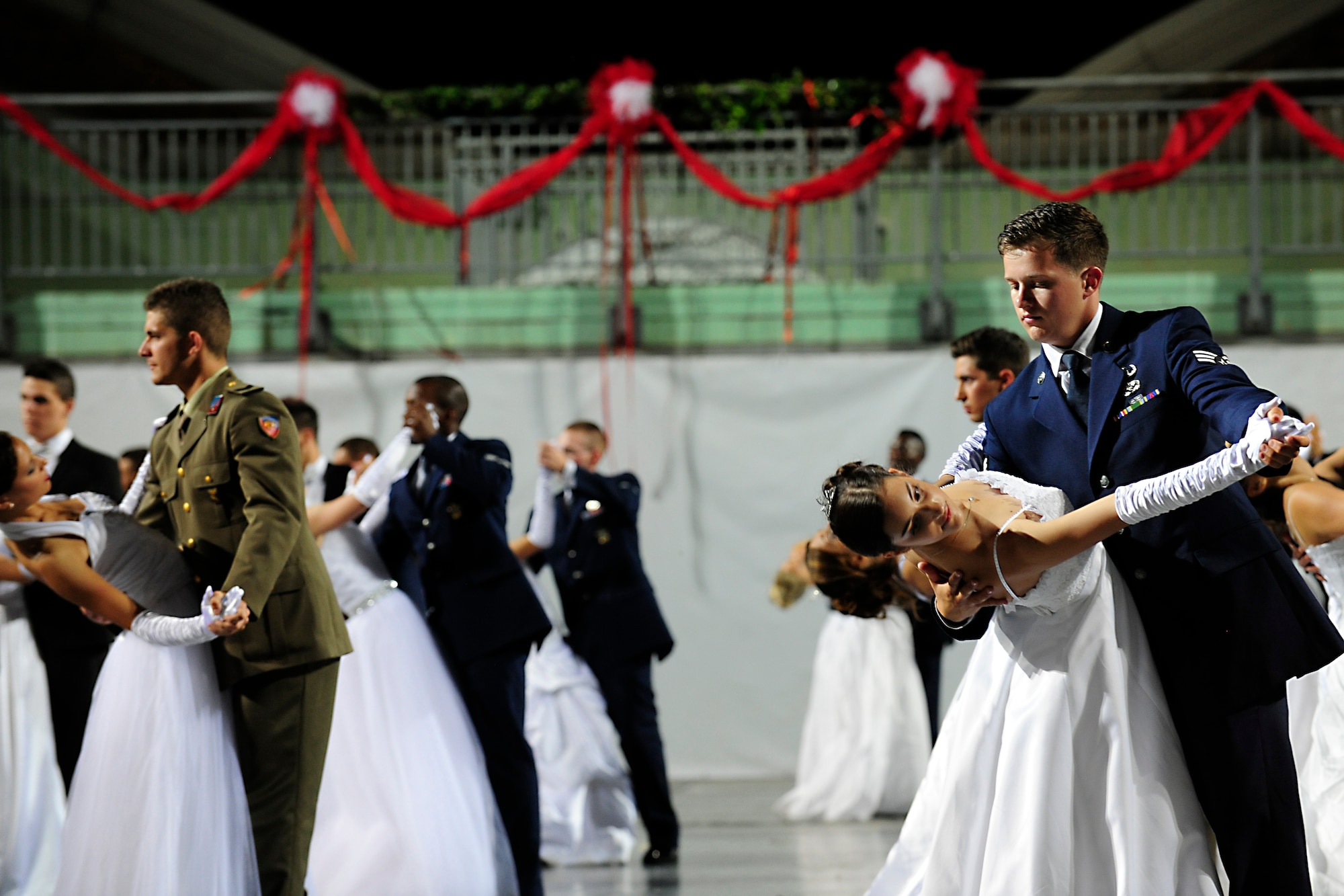 Senior Airman Joseph Schmidt, 31st Civil Engineer Squadron explosive ordnance disposal technician, dips his partner, Elena Tiozzo, during the 16th Annual Debutant Ball in Cordenons, Italy, June 22, 2014. The ball hosted 29 debutants who were accompanied by Team Aviano Airmen, Italian army soldiers and other local Italians. (U.S. Air Force photo/Airman 1st Class Ryan Conroy)