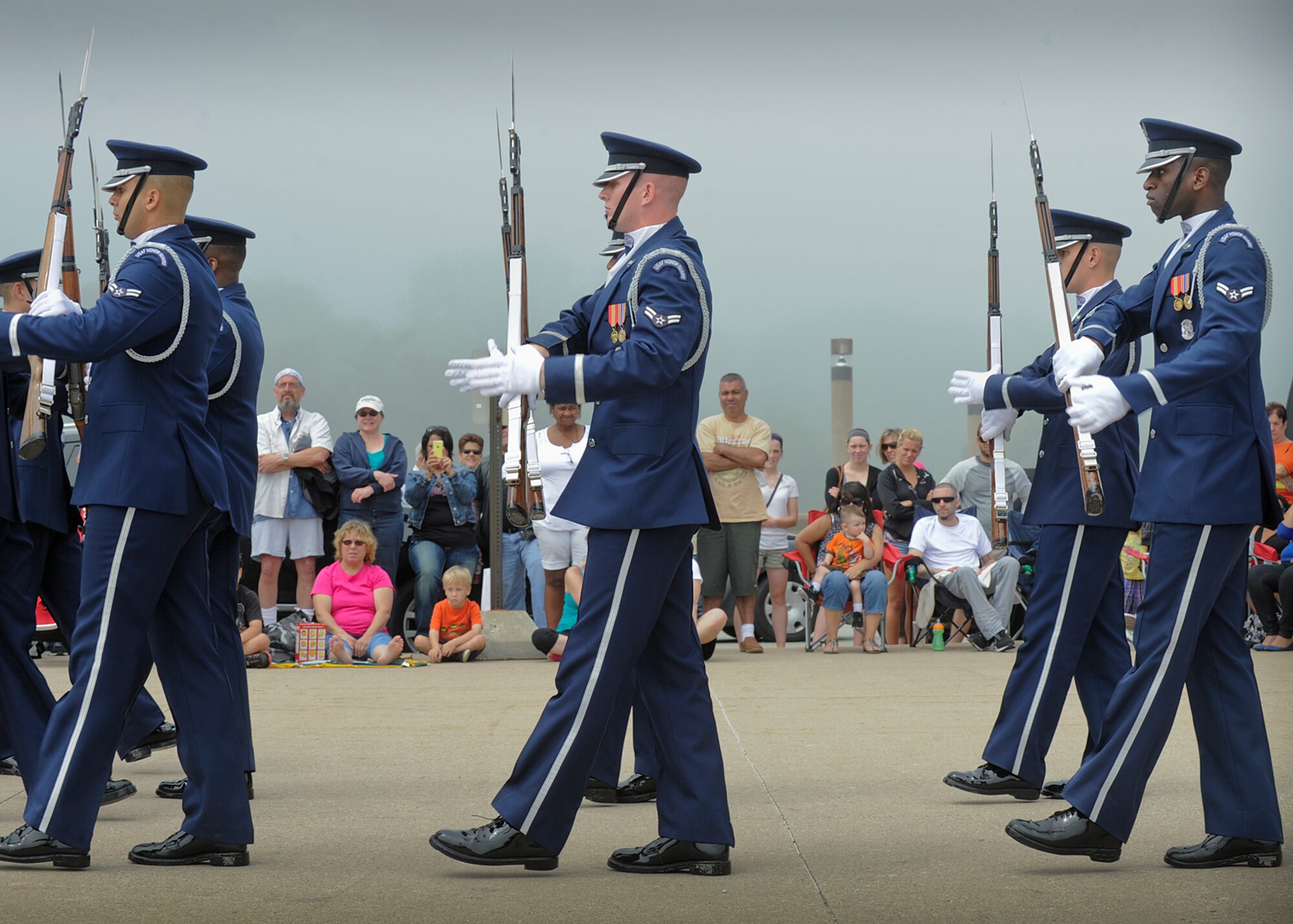 The U.S. Air Force Drill Team performs for a crowd at the Milwaukee lakefront during the Milwaukee Air & Water Show June 22, 2014. Although heavy fog prevented the aviation portion of the air show, the Drill Team performed to hundreds of show goers June 21 and 22. The Drill Team is on a nine-day, seven-city, 10-performance tour across Wisconsin, Minnesota, South Dakota, Wyoming, and Nebraska. (U.S. Air Force Photo/1st Lt. Nathan Wallin)