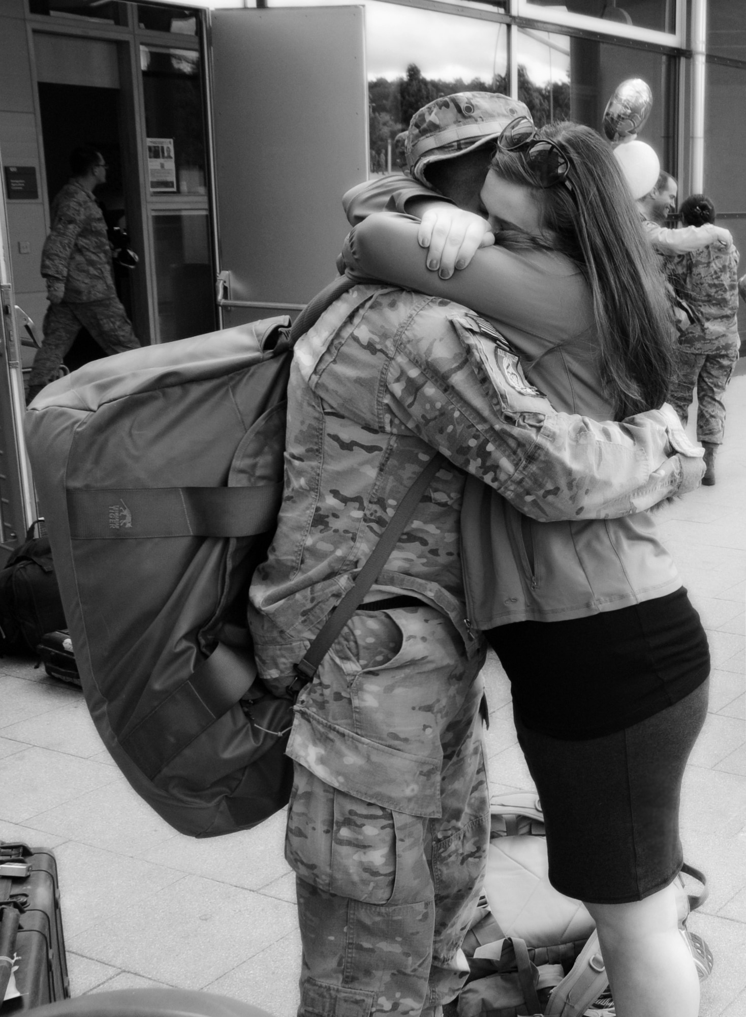 Senior Airman Chris Willis is greeted by his wife, Rena, after returning home from a six-month deployment to Afghanistan, May 15, 2013, Ramstein Air Base, Germany. (courtesy photo)