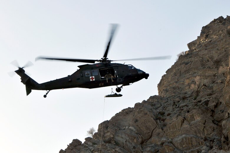 Members of the 83rd Expeditionary Rescue Squadron Guardian Angel transport a downed F-16 Fighting Falcon pilot using an HH-60G Pave Hawk, Bagram Air Field, Afghanistan April 4, 2013. The 83rd ERQS Guardian Angel’s mission is to rescue, recover and return American or allied forces in times of danger or extreme duress. (U.S. Air Force photo/Senior Airman Chris Willis)