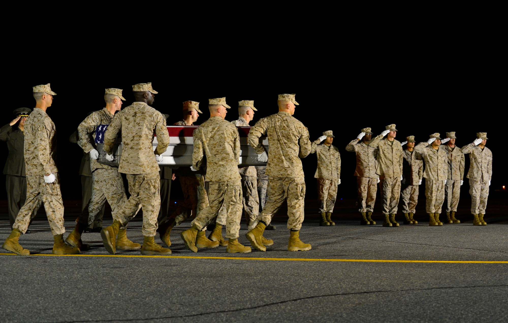 A. U.S. Marine Corps carry team transfers the remains of Lance Cpl. Adam F. Wolff of Cedar Rapids, Iowa, June 23, 2014, at Dover Air Force Base, Del. Wolff was assigned to the 2nd Combat Engineer Battalion, 2nd Marine Division, II Marine Expeditionary Force, Camp Lejeune, N.C. (U.S. Air Force photo/Airman First Class Zachary Cacicia)