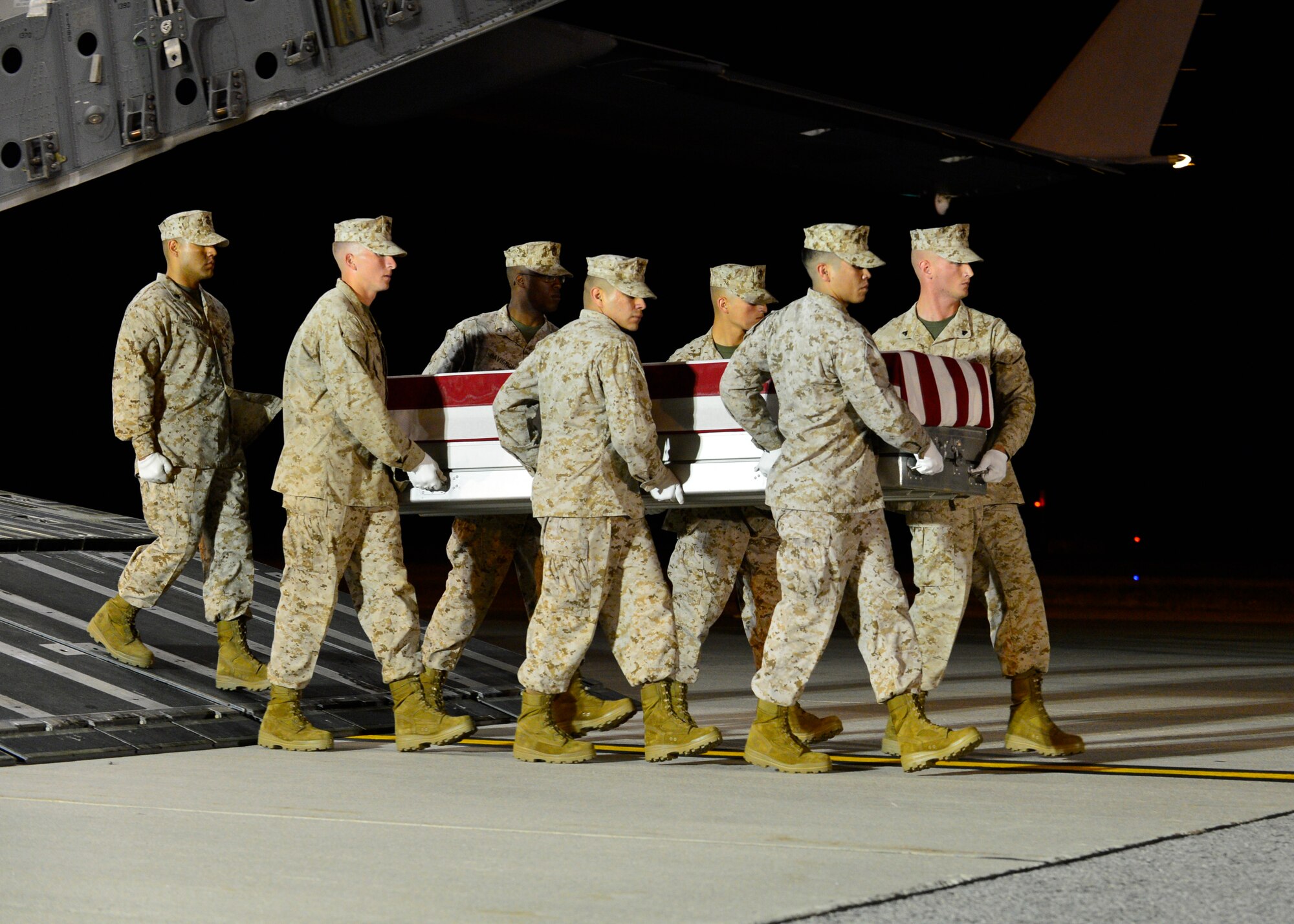 A. U.S. Marine Corps carry team transfers the remains of Lance Cpl. Brandon J. Garabrant of Peterborough, N.H., June 23, 2014, at Dover Air Force Base, Del. Garabrant was assigned to the 2nd Combat Engineer Battalion, 2nd Marine Division, II Marine Expeditionary Force, Camp Lejeune, N.C. (U.S. Air Force photo/Airman First Class Zachary Cacicia)