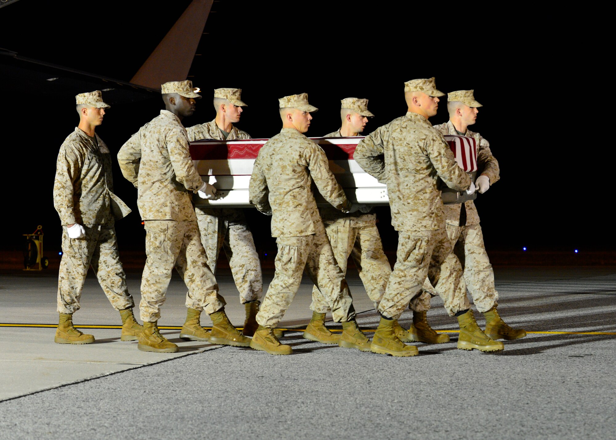 A. U.S. Marine Corps carry team transfers the remains of Staff Sgt. David H. Stewart of Stafford, Va., June 23, 2014, at Dover Air Force Base, Del. Stewart was assigned to the 2nd Combat Engineer Battalion, 2nd Marine Division, II Marine Expeditionary Force, Camp Lejeune, N.C. (U.S. Air Force photo/Airman First Class Zachary Cacicia)