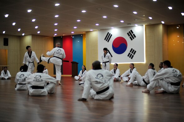 Airmen perform one-on-one taekwondo training with the instructors at the Taekwondowon Center in Muju, Republic of Korea, June 11, 2014. The training was part of a tour conducted by the Kunsan Air Base public affairs community relations office, which is scheduled to have five more tours through November. The tour gave American service members a better understanding of South Korean culture and built a better relationship between the two countries. (U.S. Air Force photo by Senior Airman Taylor Curry/Released) 