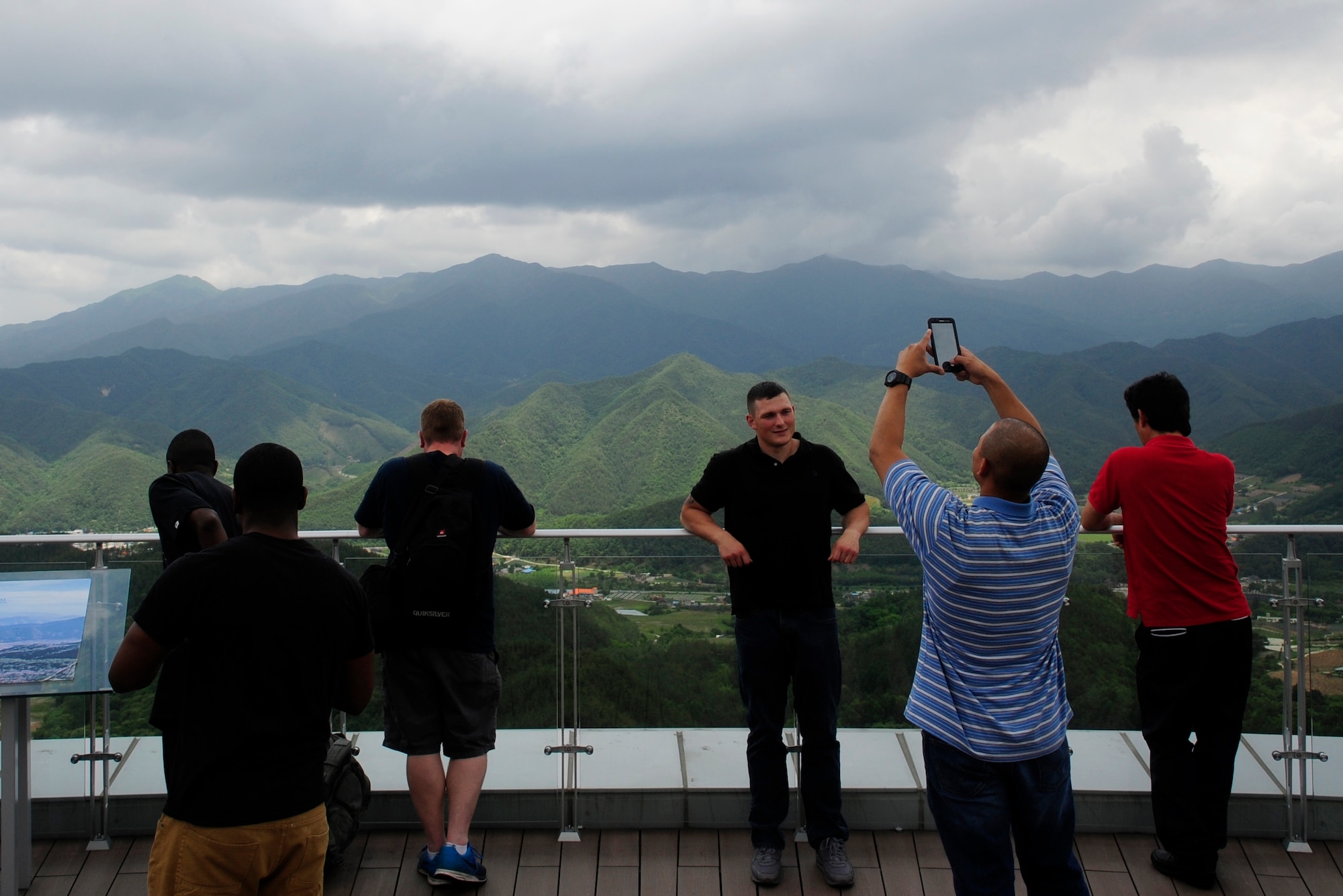 Airmen from Kunsan Air Base take photos of the view from an observatory tower during a tour at the Taekwondowon Center in Muju, Republic of Korea, June 11, 2014. The Airmen also had the opportunity to learn taekwondo from the instructors of the Taekwondowon Center. The tour gave American service members a better understanding of South Korean culture and built a better relationship between the two countries. (U.S. Air Force photo by Senior Airman Taylor Curry/Released) 