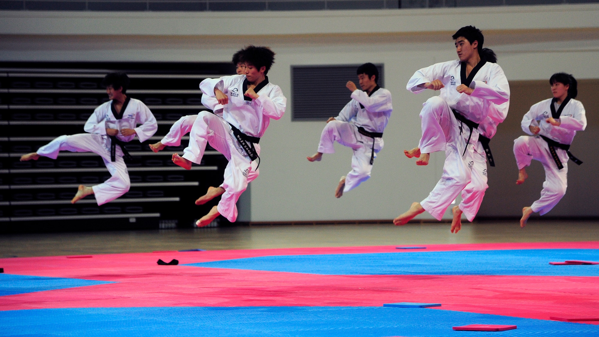 Students of the Taekwondowon Center give a demonstration of taekwondo to Kunsan Air Base Airmen during a tour of the center in Muju, Republic of Korea, June 11, 2014. The tour gave American service members a better understanding of South Korean culture and built a better relationship between the two countries. The tour was conducted by the Kunsan public affairs community relations office, which is scheduled to have five more tours through November. (U.S. Air Force photo by Senior Airman Taylor Curry/Released)  