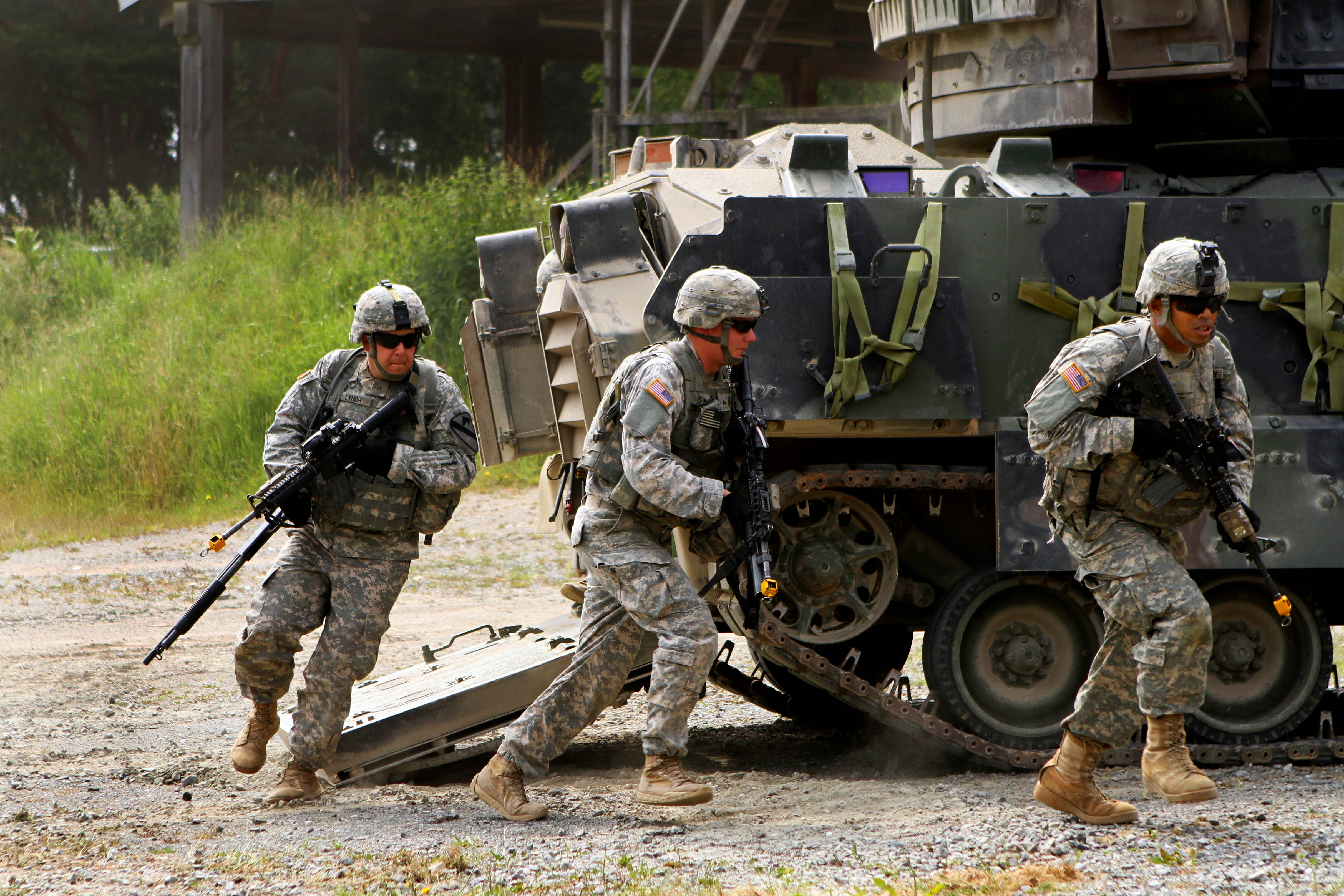 U.S. soldiers dismount from their M2 Bradley Fighting vehicle during