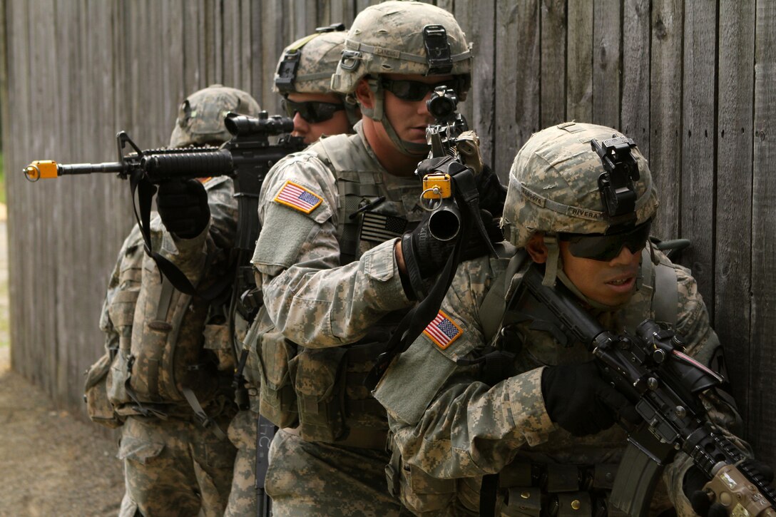 U.S. soldiers move along a wall in a stack formation during a fire team ...