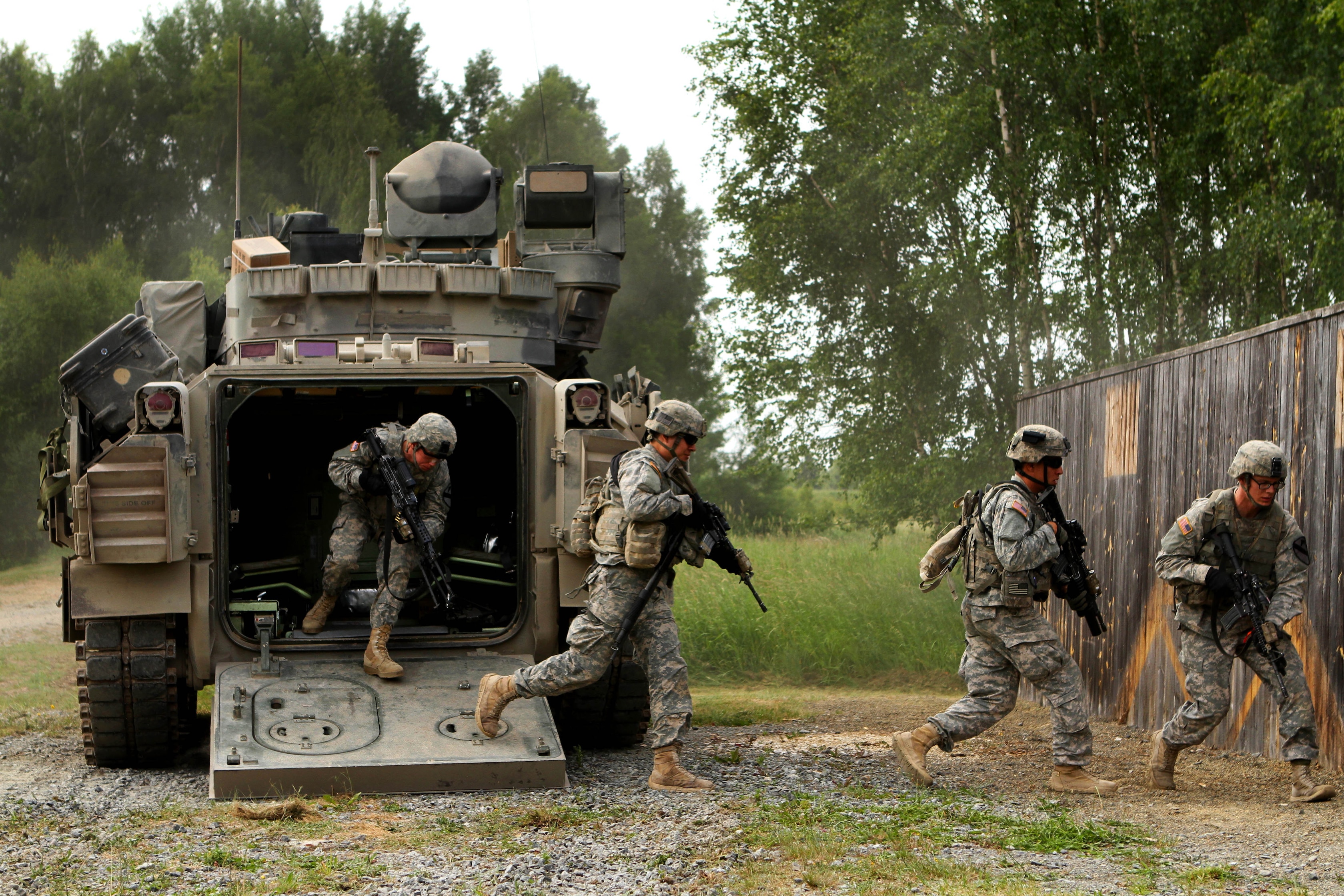 U.S. soldiers dismount from their M2 Bradley Fighting vehicle during a