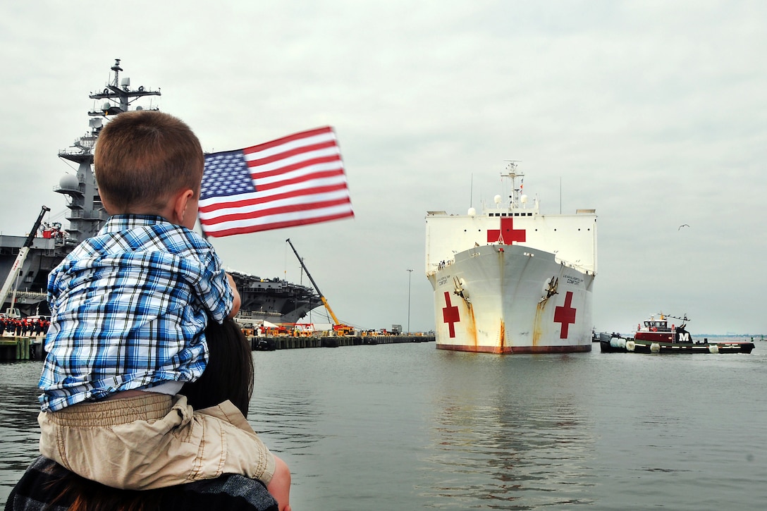 Family and friends look on as the Military Sealift Command hospital ship USNS Comfort arrives at Naval Station Norfolk, Va., Sept. 2, 2011. Comfort deployed as the primary platform for Continuing Promise 2011, a five-month humanitarian assistance mission to nine countries in Central and South America and the Caribbean.  
