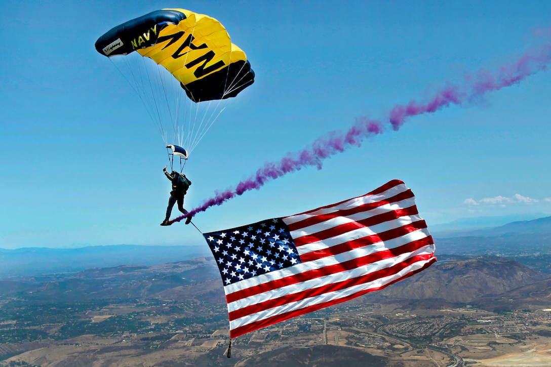 Navy Chief Warrant Officer Keith Pritchett flies a large American flag above Westview High School in San Diego, Aug. 24, 2011. Pritchett is a SEAL assigned to the Leap Frogs, the Navy parachute demonstration team, which performed during the first day of the school. 
