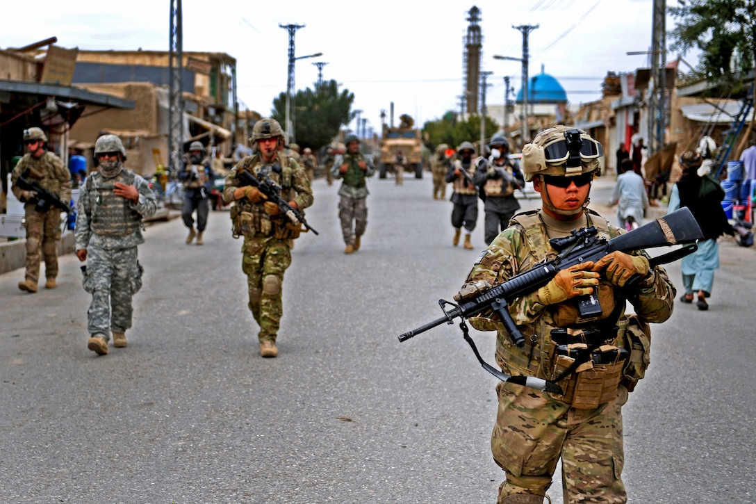 U.S. Army Pfc. Johnny Nguyen and other Provincial Reconstruction Team Zabul members patrol Qalat City, Afghanistan, Sept. 2, 2011. Nguyen, a rifleman and member of the team's security force, is deployed from the Massachusetts National Guard.  
