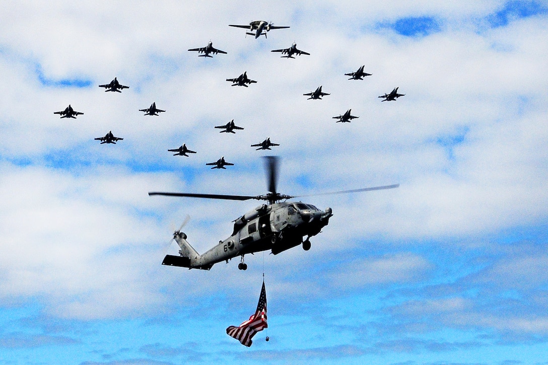 U.S. Navy aircraft assigned to Carrier Air Wing 14 fly over the aircraft carrier USS Ronald Reagan during a "tiger cruise" air show in the Pacific Ocean, Sept. 5, 2011. Tiger cruises allow friends and family of deployed sailors and Marines to spend time aboard a sea-going vessel to experience the ship's day-to-day operations. Ronald Reagan is returning from a seven-month deployment. 