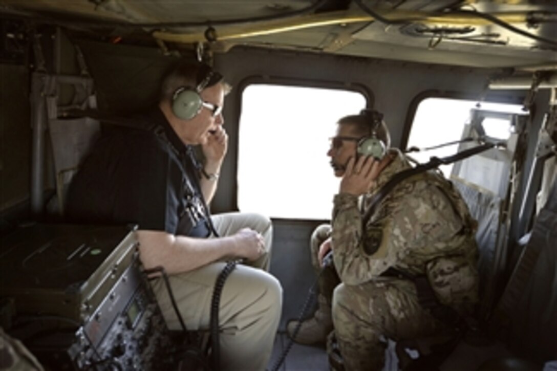 U.S. Deputy Defense Secretary Bob Work, left, talks with U.S. Army Maj. Gen. Jeffrey N. Colt,  deputy commander for U.S. Forces Afghanistan, while flying in a UH-60 Black Hawk helicopter from Kabul to Bagram Airfield, Afghanistan, June 24, 2014. Work visited Afghanistan to meet with leaders.
