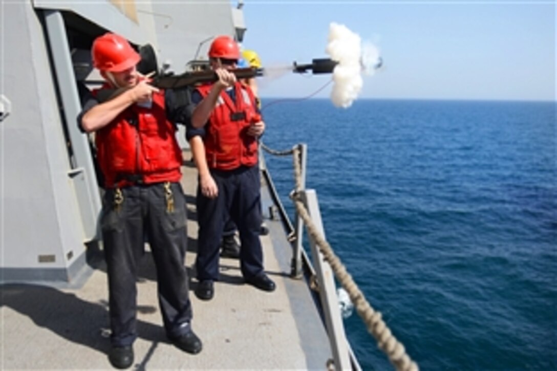 U.S. Navy Seaman Daniel Stelletell, left, fires a shot line during replenishment-at-sea with the USNS Big Horn aboard the USS Mesa Verde in the Persian Gulf, June 19, 2014. The Mesa Verde is part of the Bataan Amphibious Ready Group and with the embarked 22nd Marine Expeditionary Unit, is deployed in support of maritime security operations and theater security cooperation efforts in the U.S. 5th Fleet area of responsibility.