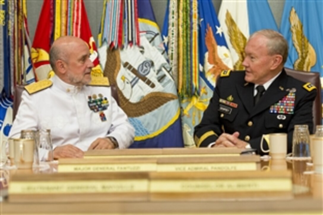 U.S. Army Gen. Martin E. Dempsey, chairman of the Joint Chiefs of Staff, talks with Italian Navy Adm. Luigi Binelli Mantelli, chief of Italy's defense staff, in "the tank,"  a secure conference room, at the Pentagon, June 24, 2014. The two defense leaders met to discuss issues of mutual importance.