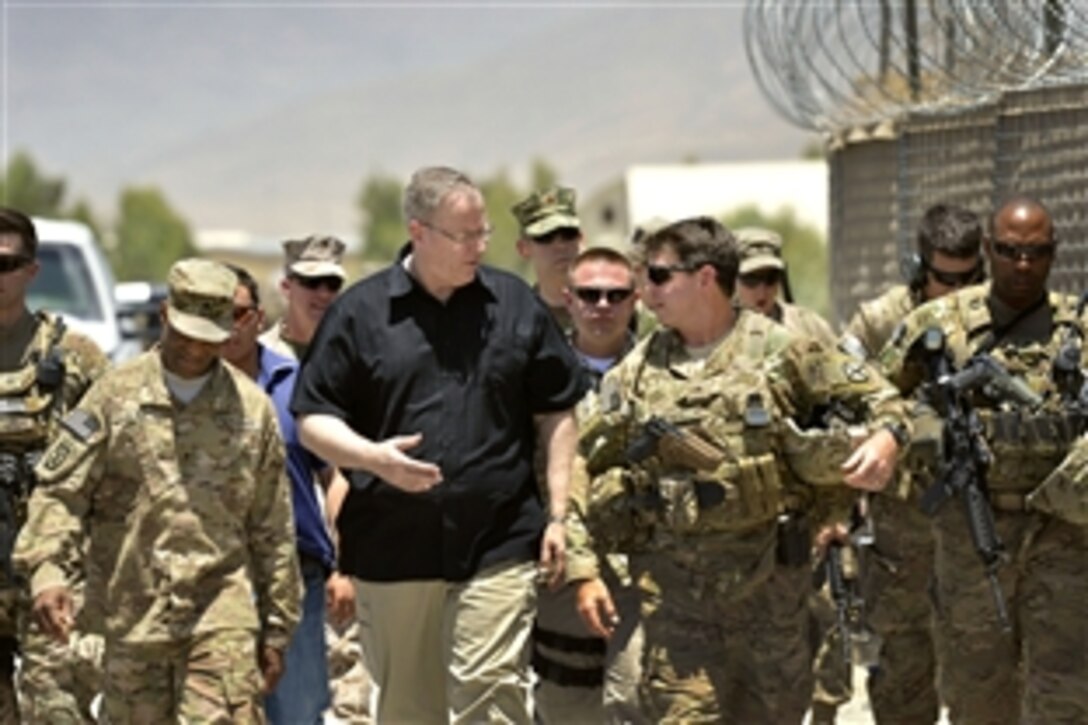U.S. Deputy Defense Secretary Bob Work, center left, talks with U.S. Army Maj. Gen. Jeffrey N. Colt, deputy commander for U.S. Forces Afghanistan, as they walk back to an awaiting UH-60 Black Hawk helicopter after visiting Forward Operating Base Gamberi, Afghanistan, June 24, 2014.