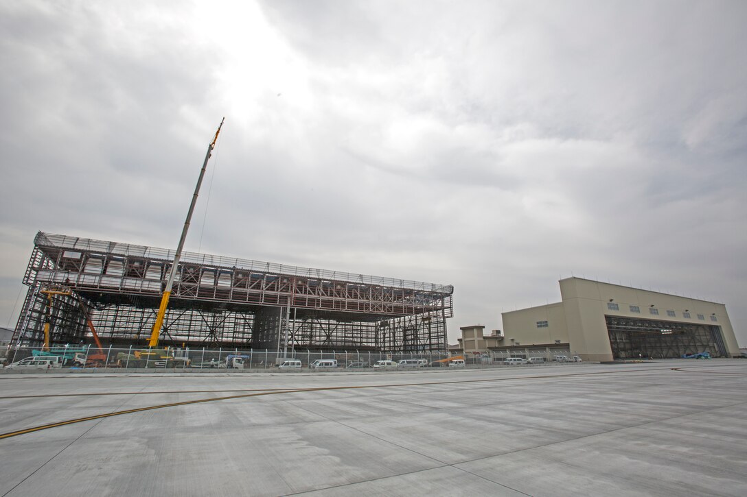 Construction workers, work to complete, what will be, the future location of Marine Aerial Refueler Transport Squadron 152 aboard Marine Corps Air Station Iwakuni, Japan. This Transfer of the KC-130J Super Hercules and the Marines attached to VMGR-152 will reduce the Marine presence in Ginowan City, Okinawa, by approximately 15 aircraft and 350 personnel.