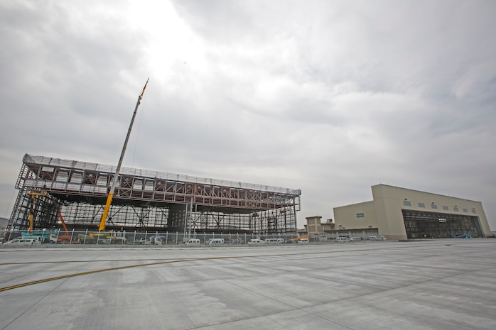 Construction workers, work to complete, what will be, the future location of Marine Aerial Refueler Transport Squadron 152 aboard Marine Corps Air Station Iwakuni, Japan. This Transfer of the KC-130J Super Hercules and the Marines attached to VMGR-152 will reduce the Marine presence in Ginowan City, Okinawa, by approximately 15 aircraft and 350 personnel.