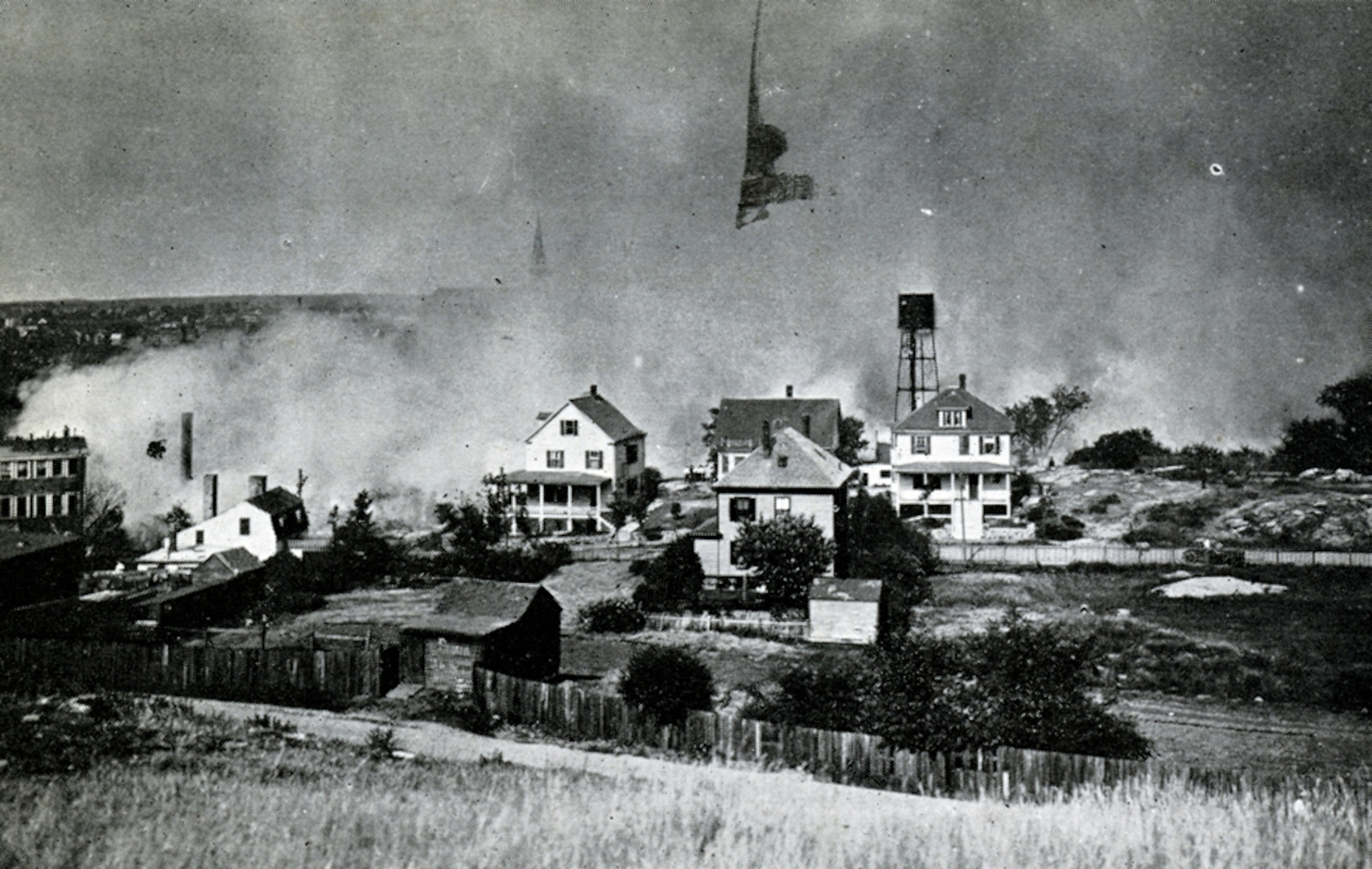 A view of the great fire in Salem, Massachusetts, on June 25, 1914, as seen from Gallows Hill. National Guard units responded in force to assist civilian authorities with managing the disaster.