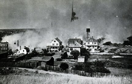 A view of the great fire in Salem, Massachusetts, on June 25, 1914, as seen from Gallows Hill. National Guard units responded in force to assist civilian authorities with managing the disaster.