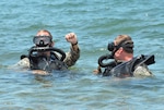 Florida Army National Guard Soldiers from 3rd Battalion, 20th Special Forces Group, surface after a 500-meter underwater swim at the U.S. Army Special Forces Underwater Operations School in Key West, Fla., June 24, 2014. 