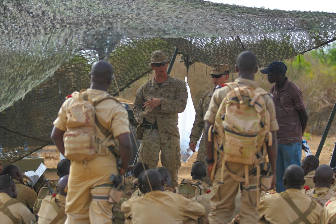 Marine Sgt. Thomas Campbell, an infantryman and class instructor with India Co., 3rd Bn., 23rd Marine Regiment, shows Burkina Faso Soldiers where suicide bombers hide explosives during Exercise Western Accord, June 20, 2014. Exercise Western Accord is a U.S. Africa Command sponsored annual joint training partnership exercise between the United States, the Economic Community of West African States and partner nations. The exercise, held in Senegal this year, is designed to increase interoperability between military forces and ensure the common ability to conduct peace operations throughout western Africa. (Photo by U.S. Army Staff Sgt. V. Michelle Woods/ 40th PAD.)