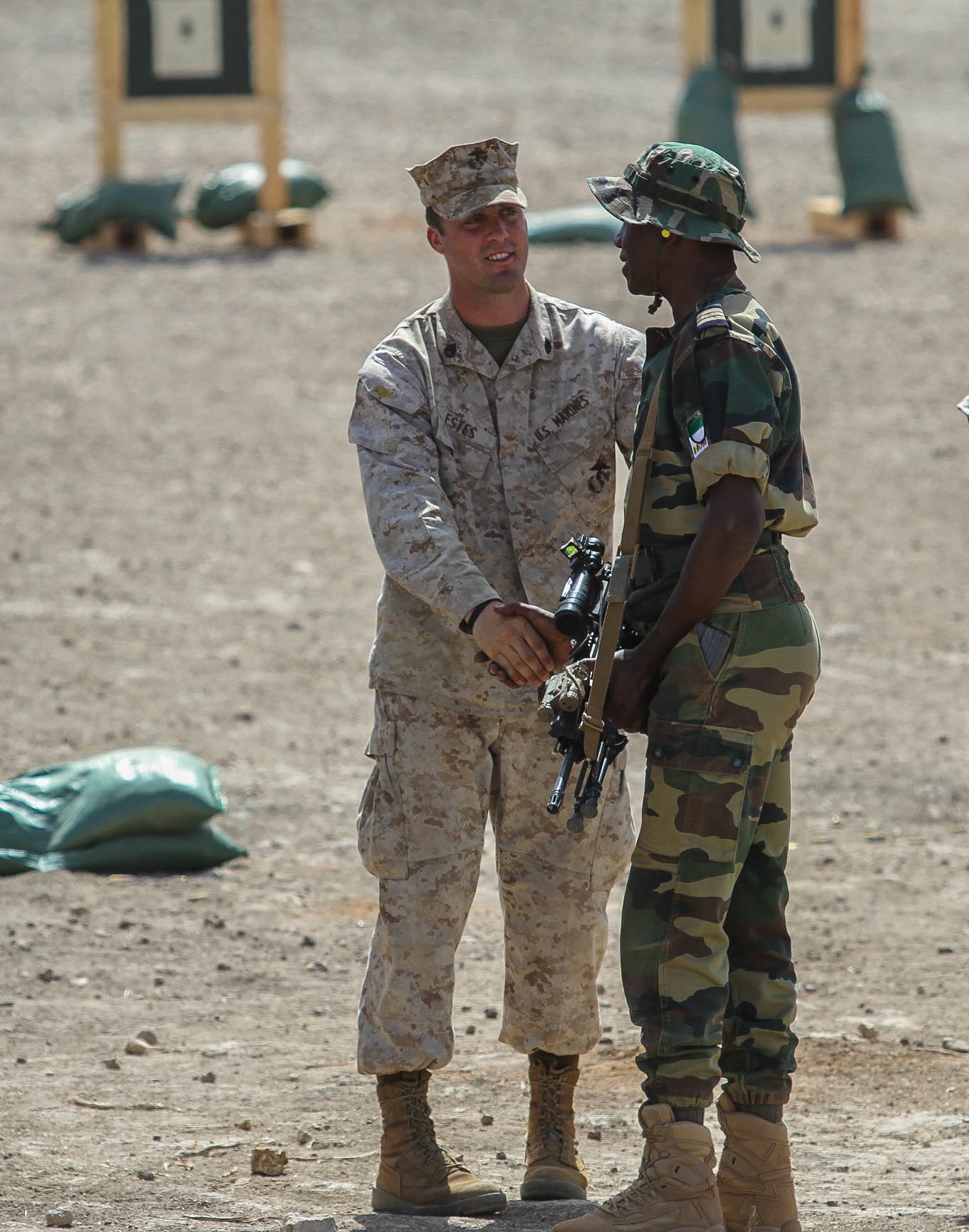 Staff Sgt. Daniel Estes, range noncommissioned officer in charge, 3rd Bn., 23rd Marine Regiment, congratulates a Ghanaian Soldier for successfully zeroing his weapon during a firing range June 19, 2014. The firing range was a part of Exercise Western Accord, a U.S. Africa Command sponsored annual joint training partnership exercise between the United States, the Economic Community of West African States and partner nations. The exercise, held in Senegal this year, is designed to increase interoperability between military forces and ensure the common ability to conduct peace operations throughout western Africa. (Photo by U.S. Army Staff Sgt. V. Michelle Woods/40th PAD)