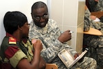 Gabon military health services Lt. Noutoubeli Marcelle, a computer scientist, speaks with U.S. Army Capt. Jamie E. Jackson, A Mississippi National Guard member and task force liaison officer for Medical Accord Central 12 taking place March 5 to 16, 2102 in Libreville, Gabon.