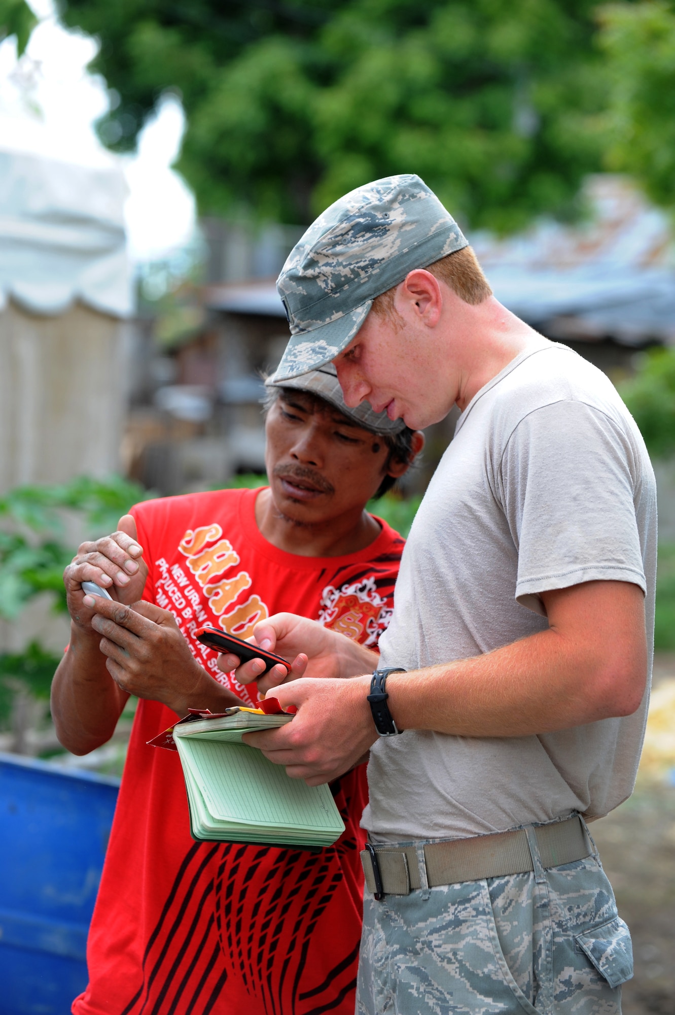 First Lt. Kory Carpenter coordinates with a local Philippine contractor June 18, 2014, at Buyong Elementary School in Barangay Maribago, Lapu-Lapu City, Philippines. Operation Pacific Unity is a bilateral Engineering Civic Action Program conducted in the Asia-Pacific region in collaboration with host nation military personnel. Carpenter was the Pacific Unity 14-6 project officer in charge. He and other Airmen from the 374th Civil Engineer Squadron, Yokota Air Base, Japan, spent 31 days building two classrooms and renovating utilities throughout the school. (U.S. Air Force photo/Staff Sgt. Amber E. N. Jacobs)