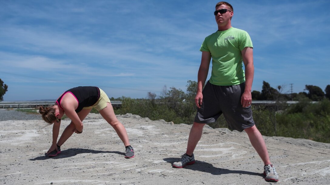 Corporal Dalton Pridmore, intelligence analyst, 15th Marine Expeditionary Unit, stretches out with his wife, Jamie Pridmore, in Oceanside, Calif., June 20, 2014. Pridmore and his wife are from Moody, Alabama. (U.S. Marine Corps photo by Lance Cpl. Anna Albrecht/Released)