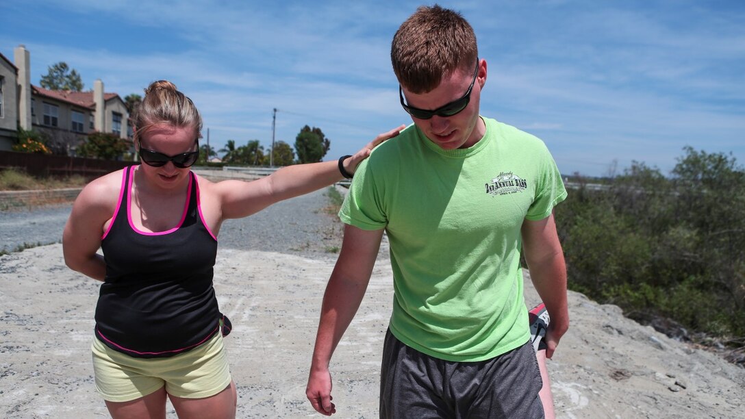 Corporal Dalton Pridmore, intelligence analyst, 15th Marine Expeditionary Unit, stretches out with his wife, Jamie Pridmore, in Oceanside, Calif., June 20, 2014. Pridmore and his wife are from Moody, Alabama. (U.S. Marine Corps photo by Lance Cpl. Anna Albrecht/Released)