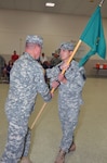 Florida Army National Guard Capt. Benjamin Ruffner accepts the guidon of the 690th Military Police Company from Army Lt. Col. Richard Elam, commander of the 254th Transportation Battalion, during a change of command ceremony in 2011.