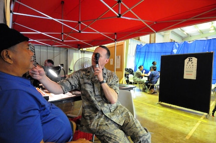 Air Force Lt. Col. Vince Simoncini, 113 Medical Group, D.C. Air NationalGuard, provides eye examinations to Hawaii residents as part of Tropic Care innovative Readiness Training on March 5, 2012. Tropic Care Innovative Readiness Training is comprised of military personnel assets of the U.S. Armed Forces to include active duty, Reserve and National Guard members who provide free medical services and conduct deployment and readiness training while forward deployed to medically underserved areas of Kaua'i, Hawaii, from Feb. 26 to March 10, 2012.