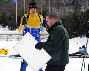 Massachusetts Army National Guard 1st Lt. Stephen Fiola shows Massachusetts Army National Guard Capt. Robert Charbonnier his target matches during pre-race training on February 26, 2012 during the 2012 Chief of the National Guard Bureau Biathlon Championships at the Camp Ethan Allen, Jericho, Vt.