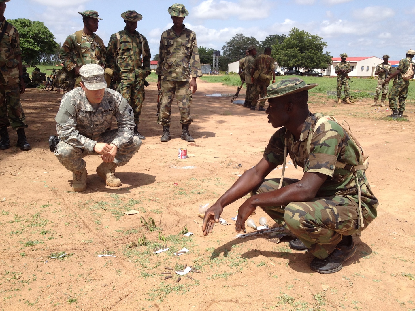 A California National Guard Special Forces Soldier from Los Alamitos-based Special Operations Detachment-U.S. Northern Command and Company A, 5th Battalion, 19th Special Forces Group (Airborne), reviews a sand table map with a Nigerian soldier in Nigeria in June.