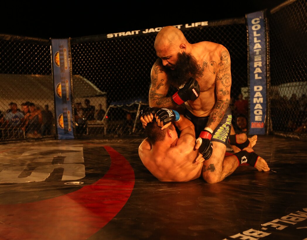 Richard "the Boogeyman" Martinez, fighter, Team Hurricane Awesome, strikes Julian Hernandez, independent fighter, during Summer Fight Night V at Del Valle Field, June 20, 2014. Martinez quickly subdued his opponent and won the fight.