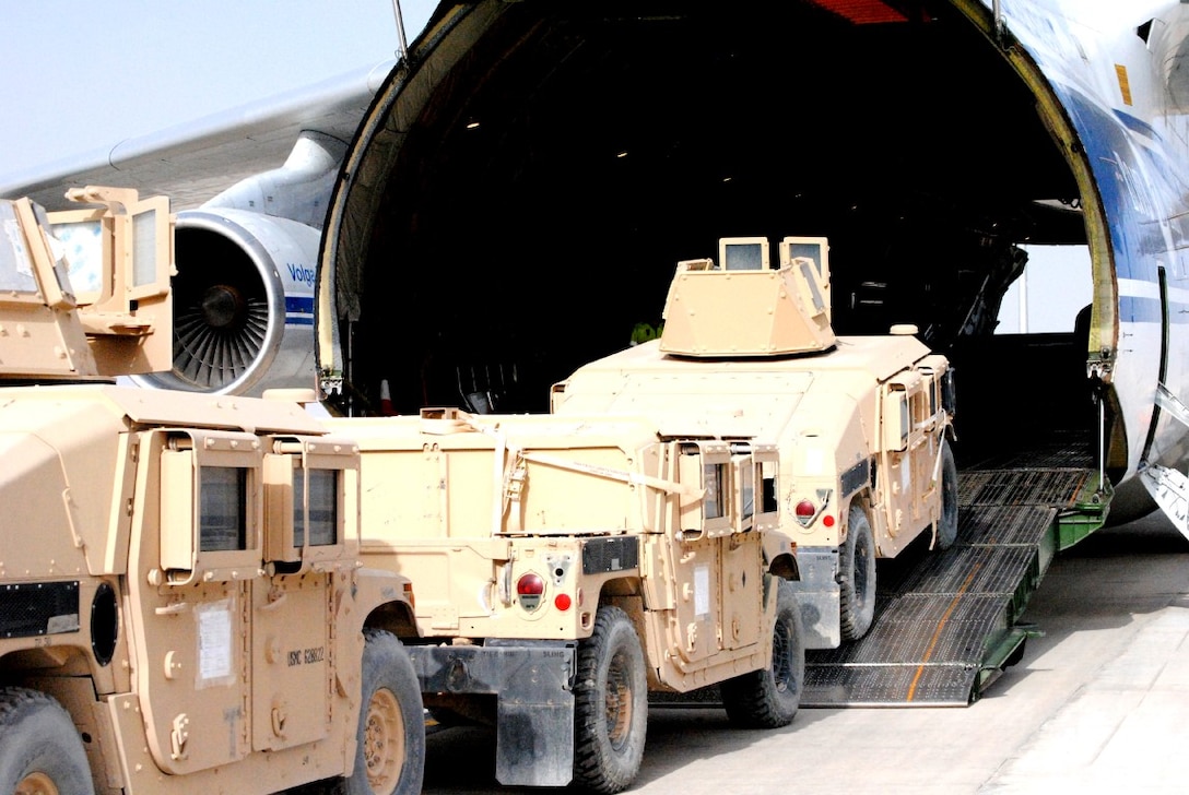 Courtesy Photo - High Mobility Multipurpose Wheeled Vehicles are loaded on to an aircraft aboard Camp Bastion, Helmand province, Afghanistan, to be shipped back to the states. Logistics Command Forward was responsible for redeploying tactical vehicles and gear to Marine Corps Logistics Base Albany, Ga., for reset and reconstitution as deployed units begin to redeploy home, prior to their flag-folding ceremony, June 1, 2014.