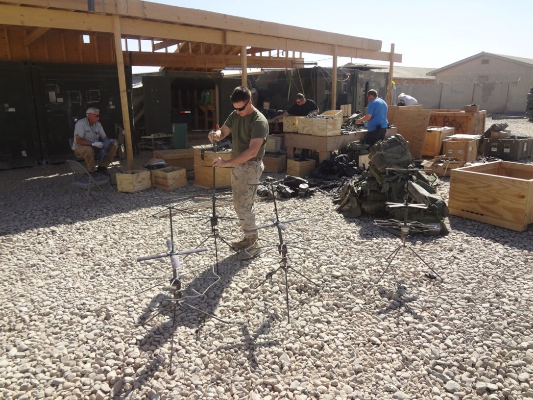 Courtesy photo - A Marine, government civilians and contractors with Logistics Command Forward inventory communication equipment during their deployment to Camp Leatherneck, Helmand province, Afghanistan. The unit was comprised of an effective and efficient staff that allows them to easily expand or contract logistical support to meet the requirements of the operational commander with minimal resources being pulled from the operating forces, prior to their flag-folding ceremony, June 1, 2014.