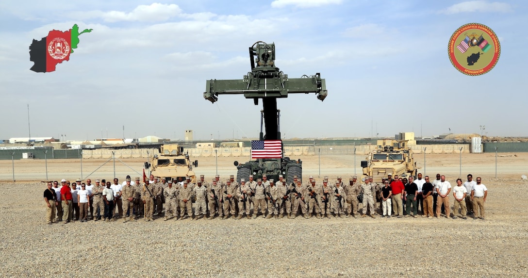 Courtesy photo - Marines, government civilians and contractors with Logistics Command Forward pose for a unit photo recently during their current deployment to Camp Leatherneck, Helmand province, Afghanistan. The unit was comprised of an effective and efficient staff that allowed them to easily expand or contract logistical support to meet the requirements of the operational commander with minimal resources being pulled from the operating forces, prior to their flag-folding ceremony, June 1, 2014.