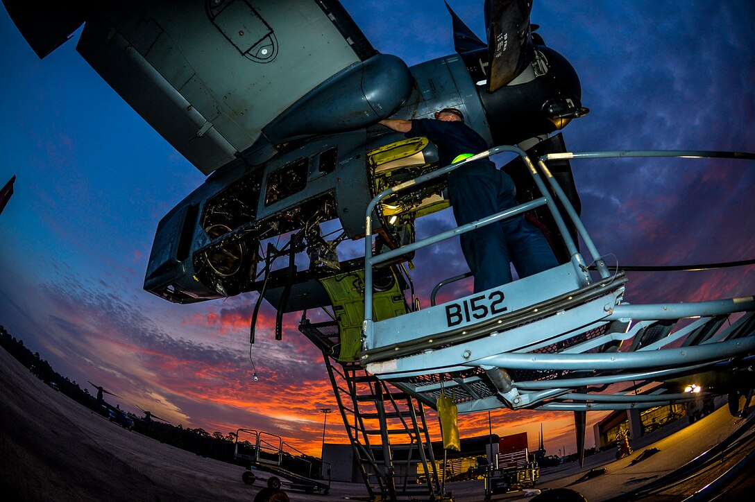 Airman 1st Class Clinton Butler, 801st Special Operations Maintenance Squadron dedicated crew chief, removes screws from a CV-22 Osprey engine on Hurlburt Field, Fla., June 13, 2014. The 801st SOAMXS routinely troubleshoots, repairs, launches and recovers aircraft. (U.S. Air Force photo/Senior Airman Christopher Callaway) 
