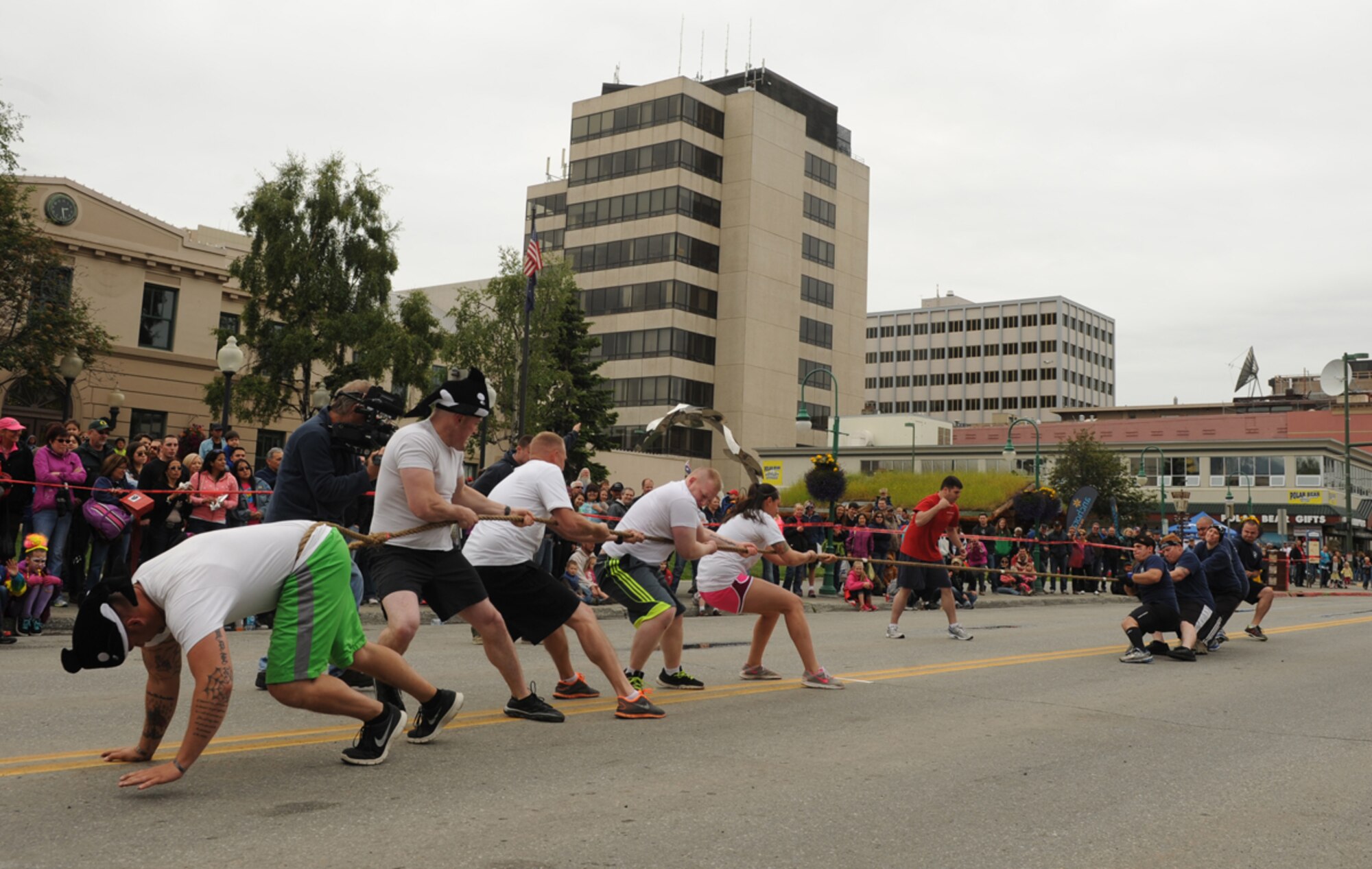 ANCHORAGE, Alaska ??? The 793rd Military Police Battalion team struggles against the 673d Civil Engineer Squadron Fire Dogs,  as the Fire Dogs defeat them in the 2014 Hero Games tug of war event on 4th Avenue in downtown Anchorage June 21, 2014. The 793rd MP Battalion still took first place in the 2014 Hero Games overall. (U.S. Air Force photo/Senior Airman Omari Bernard)