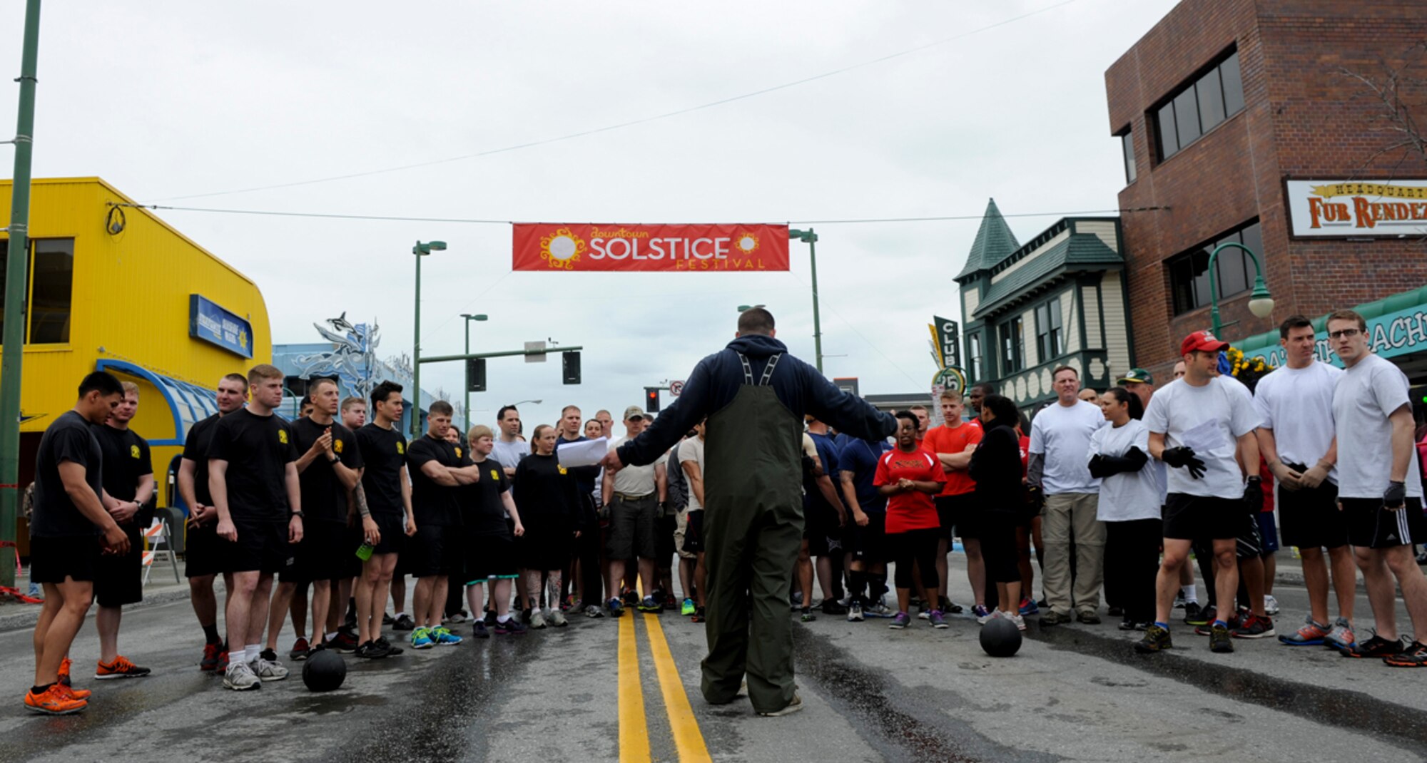 ANCHORAGE, Alaska - An event coordinator with the Anchorage Downtown Partnership briefs Airmen, Coast Guardsmen, and Soldiers on the rules and events for the 2014 Hero Games on 4th Avenue in downtown Anchorage June 21, 2014. The Hero Games are an annual event meant to honor local emergency personnel and military service members. (U.S. Air Force photo/Senior Airman Omari Bernard)