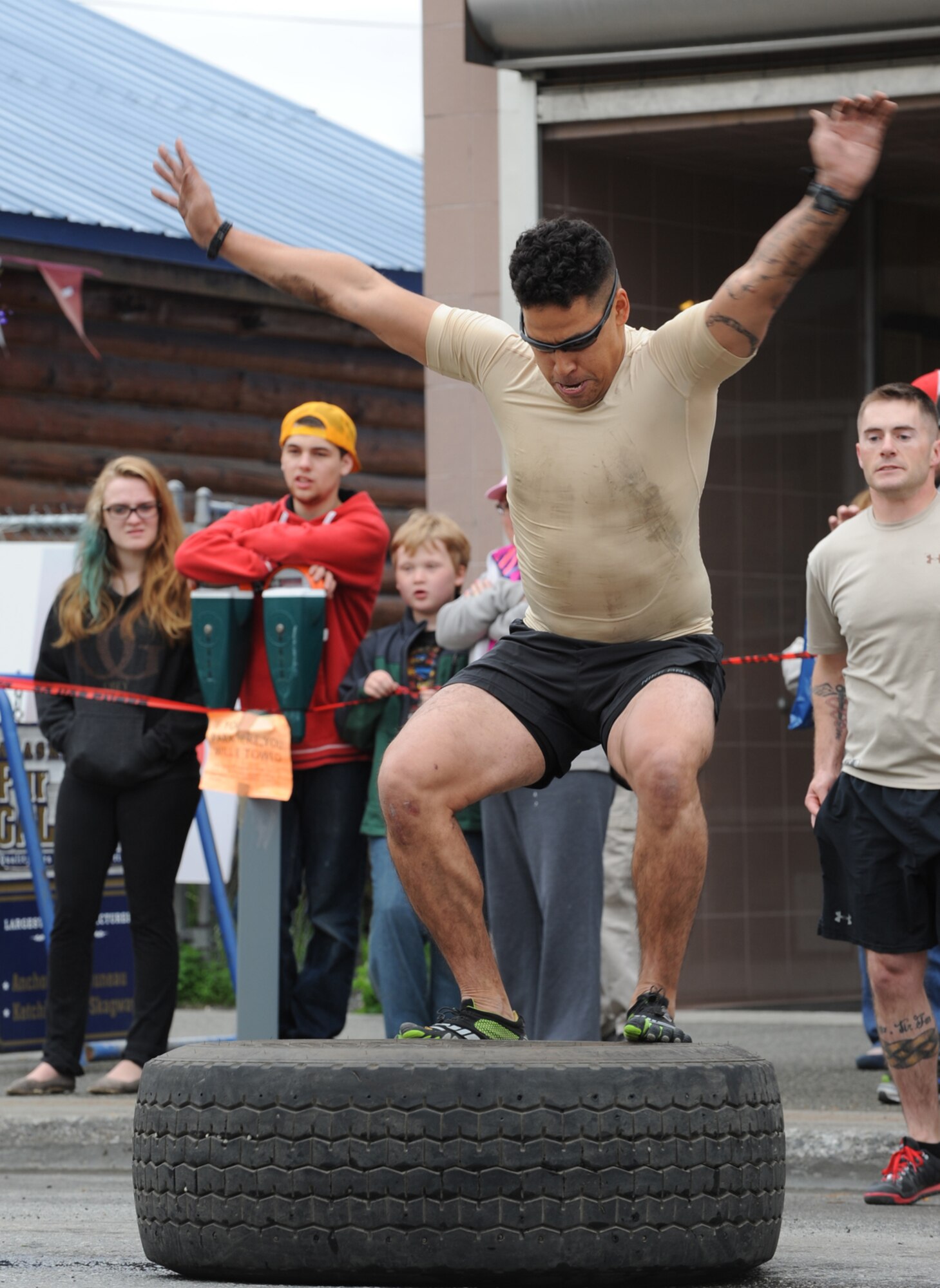 ANCHORAGE, Alaska ??? Sgt. Matthew Blanchett, 1st Battalion, 297th Battle Field Surveillance Brigade, performs a tire jump during the 2014 Hero Games on 4th Avenue in downtown Anchorage June 21, 2014. Blanchett was a member of the Army National Guard team that competed during the games. (U.S. Air Force photo/Senior Airman Omari Bernard)