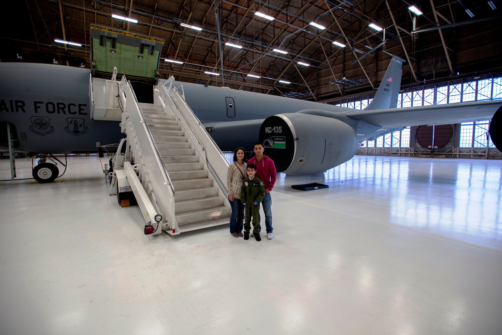Sam Diaz, his mother, Allison, and his father, Julio, stand in front of a KC-135 Stratotanker for a picture during pilot for a day at Fairchild Air Force Base, Washington, June 18, 2014. Sam was participating in the 141st Air Refueling Wing program which allows children going through challenging times to become an honorary wing pilot. (U.S. Air Force photo by Tech. Sgt. Michael Brown/Released)