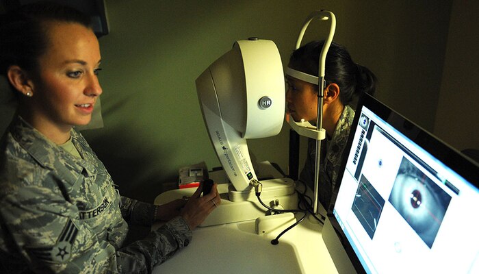 Senior Airman Nichelle Patterson, 99th Aerospace Medicine optometry technician, checks Maj. Ivy Madson’s, 99th AMDS optometry flight commander, eyes June 25, 2014, at Nellis Air Force Base, Nev. The 99th AMDS optometry clinic uses the Pentacam, a comprehensive eye scanner to detect if the patient has thin corneas and to determine if they are a good candidate for refractive surgery. (U.S. Air Force photo by Airman First Class Rachel Loftis)