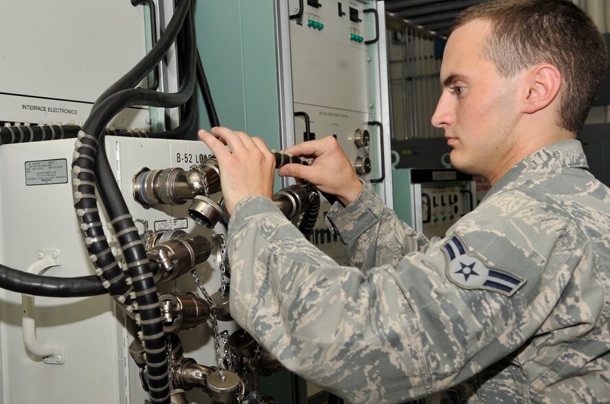 Airman 1st Class Shawn Hawkins connects a test adapter group cable to an electronic systems test set patchboard for a loaded launcher test on Barksdale Air Force Base, June 19, 2014. The test will feed commands to cruise missiles, which will send feedback to a computer in order to determine if the cruise missile is operating nominally. (U.S. Air Force photo/Airman 1st Class Benjamin Raughton)