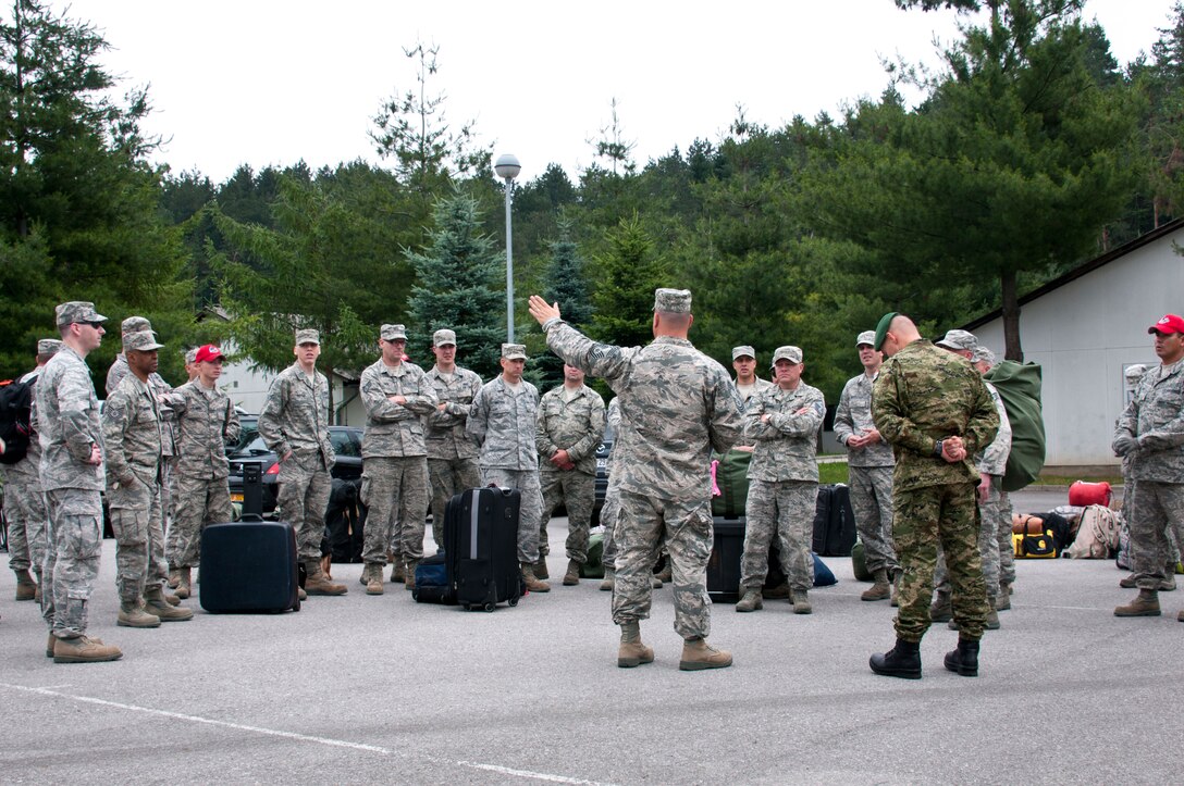 U.S. Air Force Chief Master Sgt. Kyle Johnson briefs Airmen from the 133rd Civil Engineering Squadron, 148th  Civil Engineering Squadron, and 219th Red Horse Squadron in Ogulin, Croatia, June 16, 2014. These Airmen will renovate bathrooms at an elementary school in Croatia, a Minnesota State Partner under the National Guard State Partnership Program.  (U.S. Air National Guard photo by Staff Sgt. Austen Adriaens/Released)